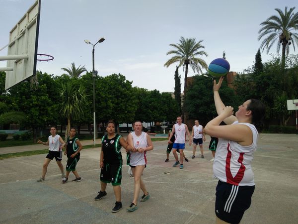 volunteers playing basketball vs students from an orphanage 