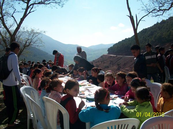 Volunteer with children in the montains